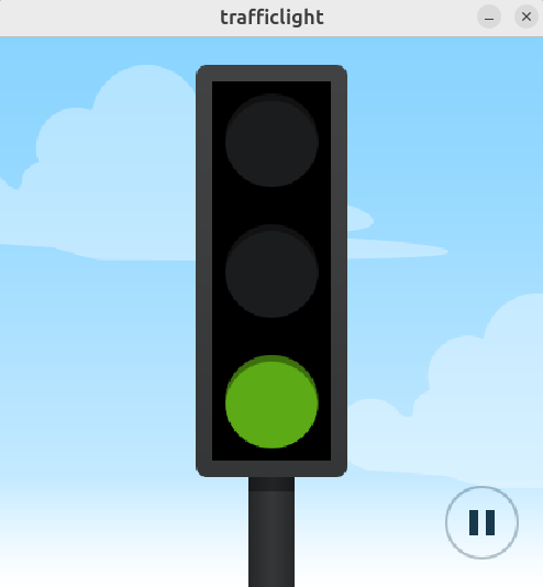 Traffic light with green light illuminated and pause button